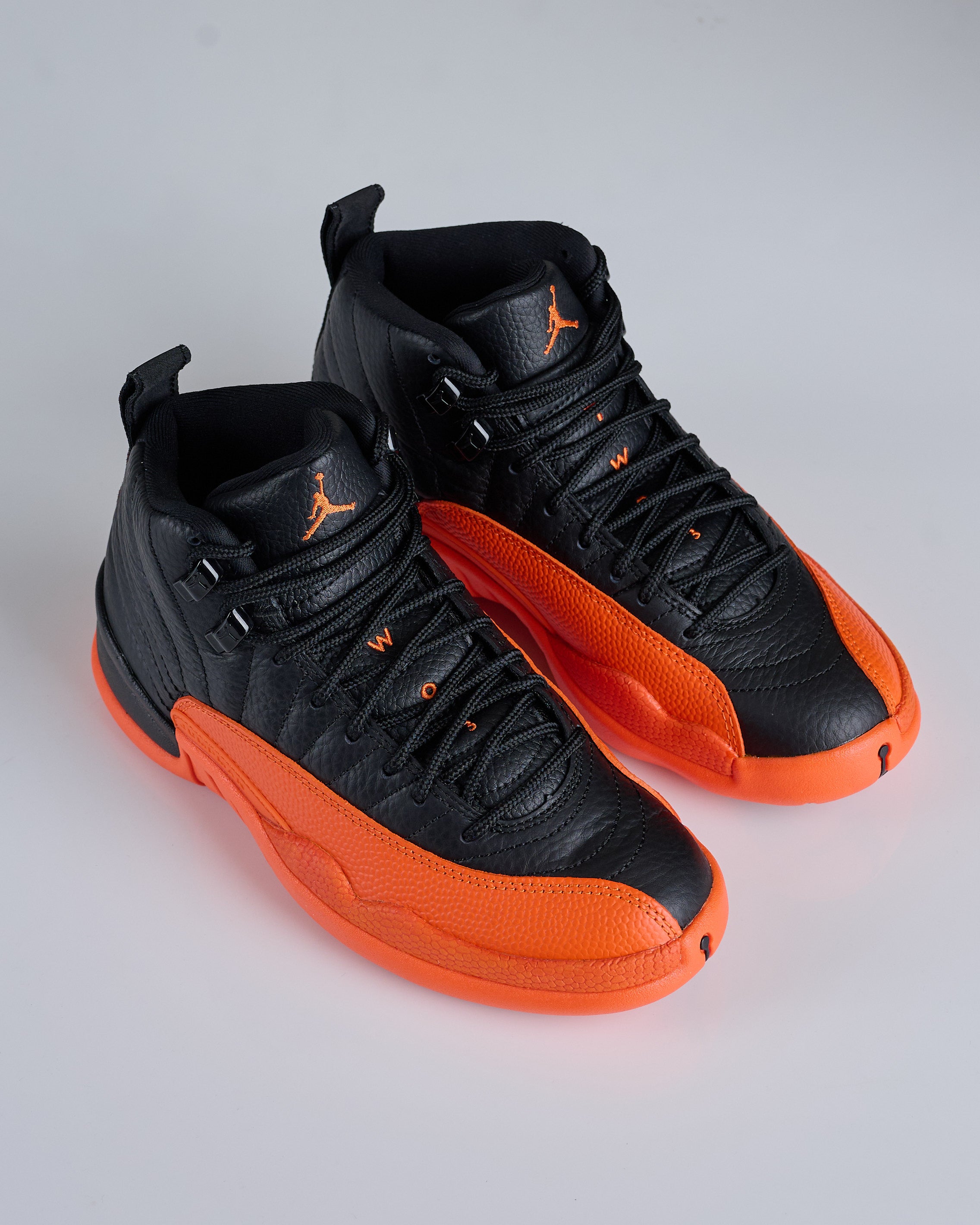 Jordan 12 black on sale orange